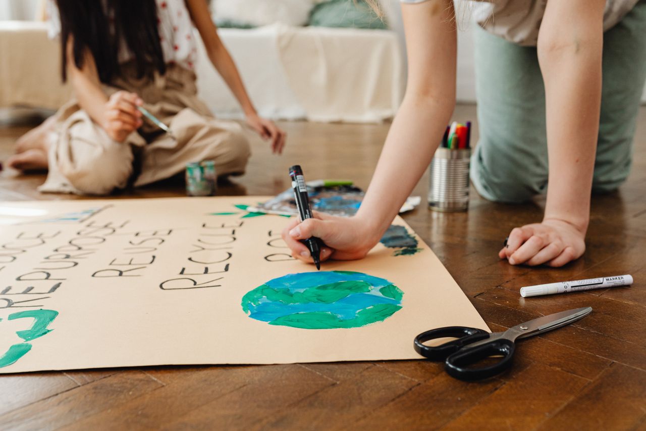 Services Children involved in an arts and crafts project to promote environmental awareness indoors.